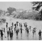 An ivory hunter’s caravan fords a stream