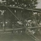 Hamilton making adjustments to his biplane, 1911