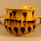 An English yellow slipware "posset pot" found on the cellar floor of the Goodsell house in North Branford. By the time Lydia Goodsell died in about 1797, this post-medieval-style earthenware cup would have been very outdated, but it was still considered serviceable - AHS, Inc., Storrs