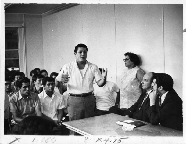 Maria Sánchez (leaning against the wall) in a meeting with city officials, Hartford, 1969