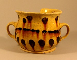 An english yellow slipware "posset pot" found on the cellar floor of the Goodsell house in North Branford. By the time Lydia Goodsell died in about 1797, this post-medieval-style earthenware cup would have been very outdated, but it was still considered serviceable - AHS, Inc., Storrs
