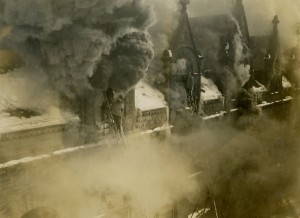 Firemen on ladders combat smoke pouring from the roof, Union Station, Hartford