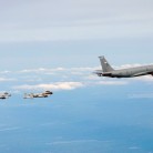 Two A-10 Thunderbolt IIs from the Connecticut Air National Guard's 103rd Fighter Wing fly in formation behind a KC-135