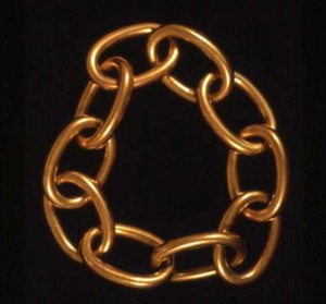 Gold chain-link bracelet symbolizing the shackles of slavery