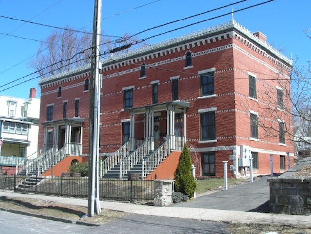 The Case Block, at 22-28 Spring Street in Bristol, Connecticut, was built as a row house block of four apartments by the builder architect Joel T. Case - Daniel Sterner, HistoricBuildingsCT.com