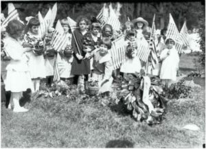 School children placing flowers on the graves of World War I servicemen