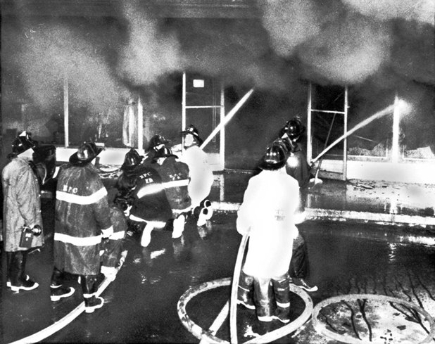 Firemen work to douse the last flames of a fire that swept through Gulliver's Restaurant