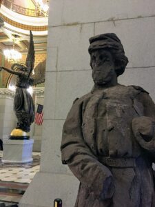 Close up of a statue of a soldier with another statue in the background