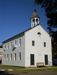 Two story white building with a steeple