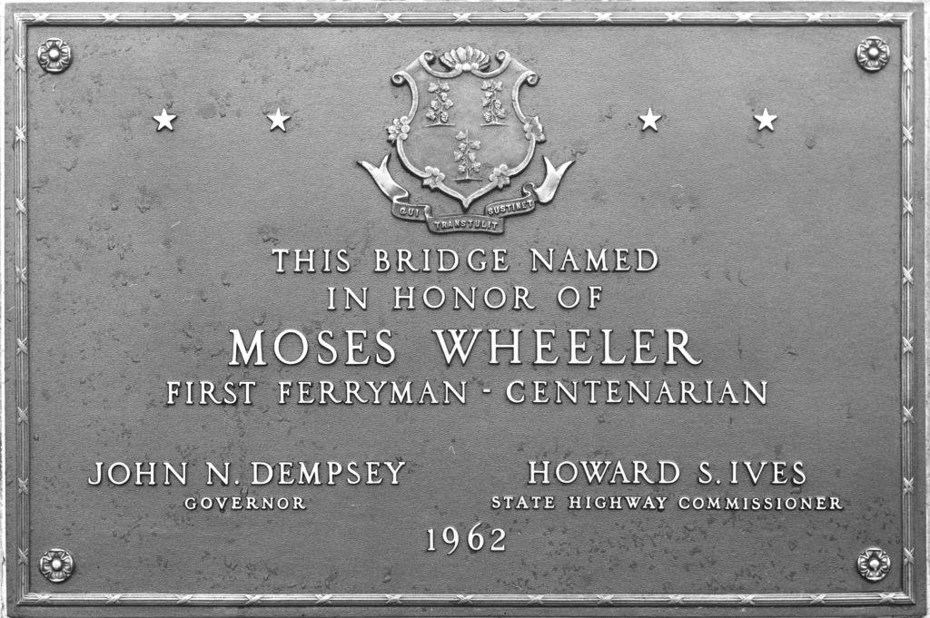 Grey plaque dedicated to Moses Wheeler with the names of the Connecticut governor and state highway commissioner in 1962