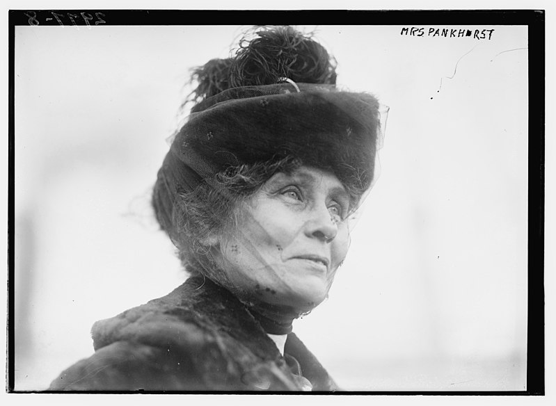 Black and white photograph of the profile of a woman wearing a hat and sheer veil over her face