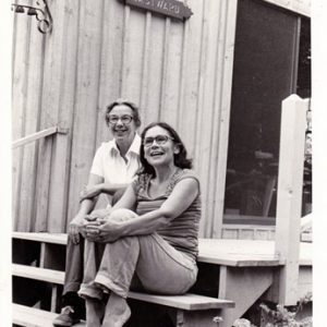 Two women sitting on the steps of a building