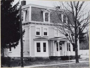 Black and white photograph of three story house