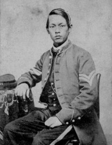 Black and white photograph of a person sitting on a chair