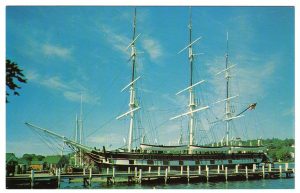 Large ship with tall masts at a dock
