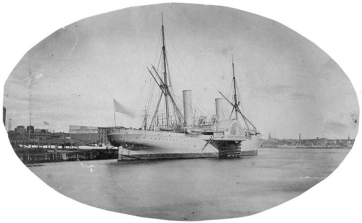 Black and white photograph of a ship at port