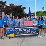 Group of students standing behind a banner reading Connecticut History Day