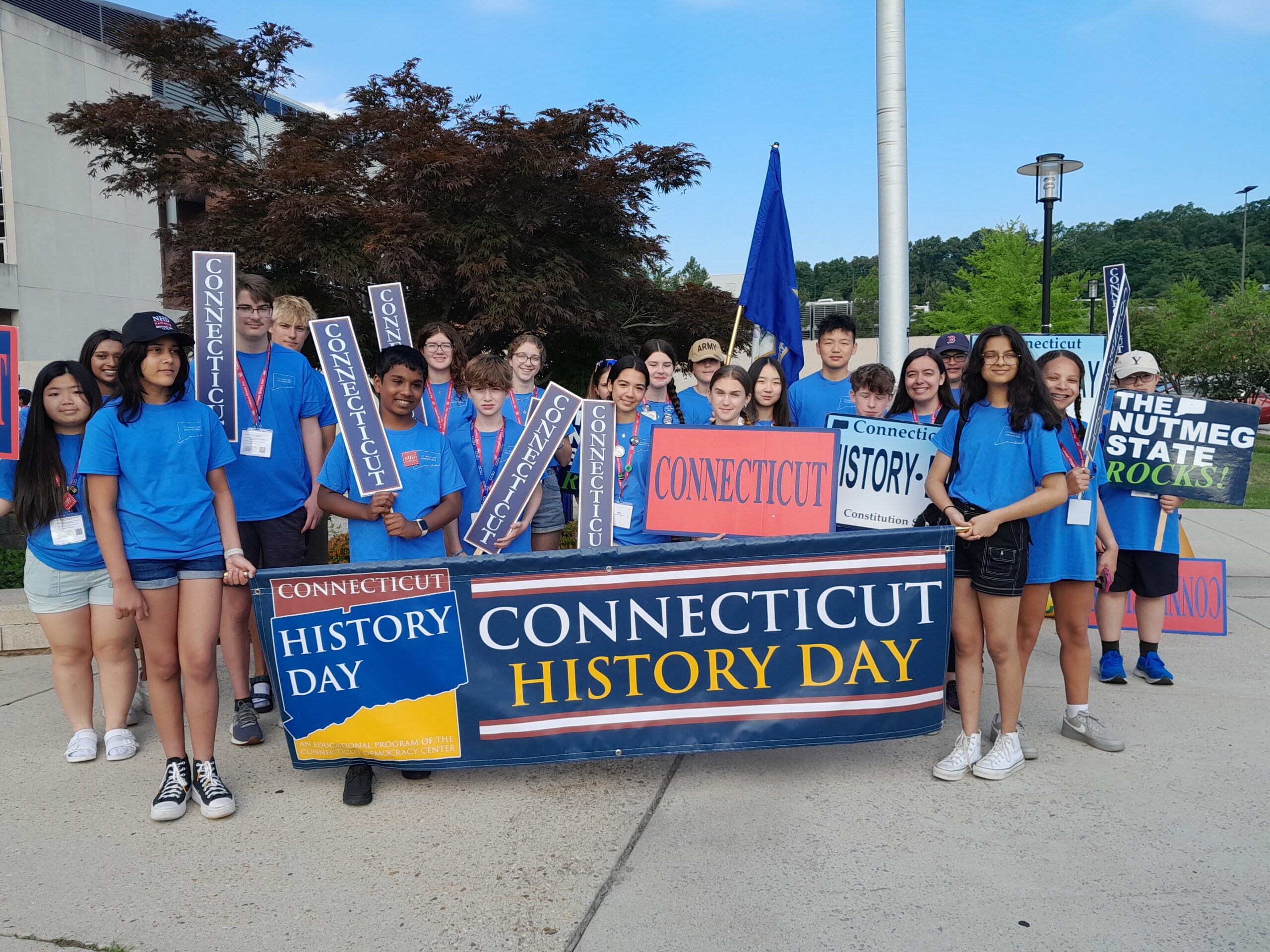 Group of students standing behind a banner reading Connecticut History Day