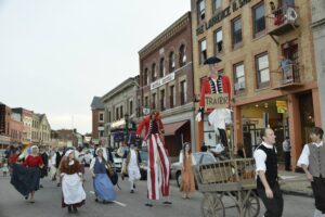 Parade of people through the streets of New London, Connecticut with a two-faced Benedict Arnold effigy