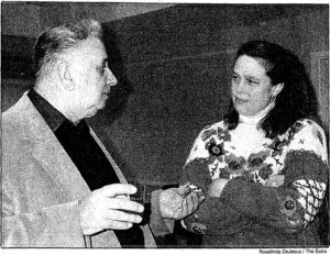 Newspaper clipping of a man talking to a woman