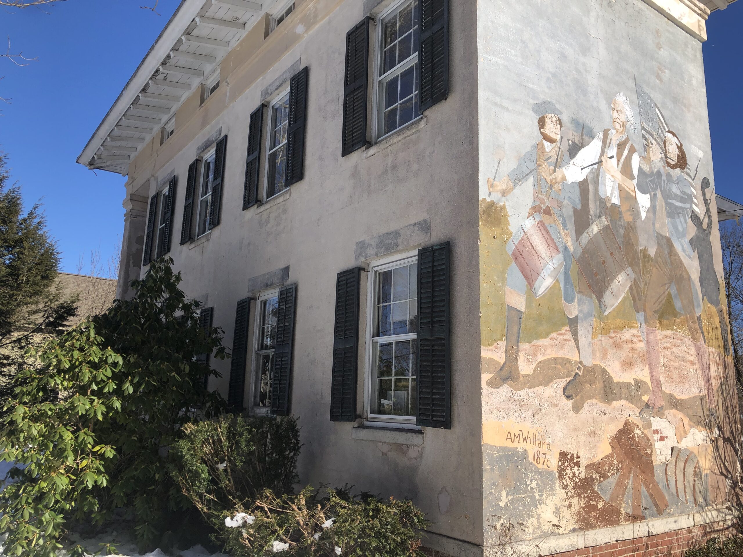 Side of a house with a painting on one wall