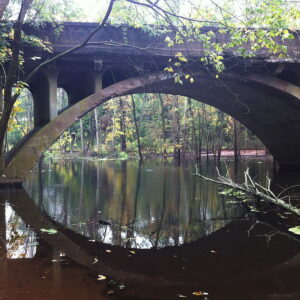 Photograph of an open-spandrel bridge over a river