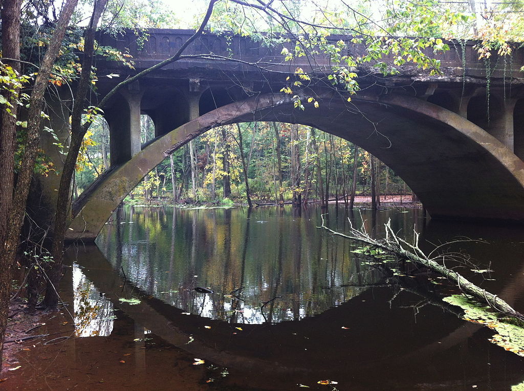 Photograph of an open-spandrel bridge over a river