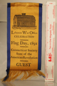 Yellow and blue ribbon with text and a print of a building