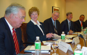 Row of seated people at a table.