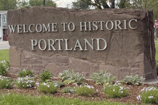 Brownstone sign with the text "Welcome to Historic Portland"