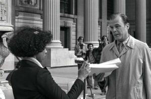 Yvette Martas, YC 81, presents University Secretary Henry Chauncey with a list of student demands that Yale divest from South Africa, Spring 1979. Members of Despierta Boricua collaborated with other groups in a movement that spread to other universities in the Northeast. Photo by David Gonzalez